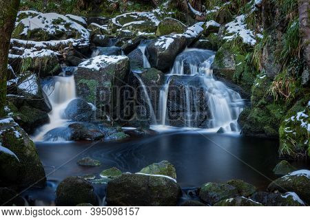 Waterfall With Moss Covered Rocks And Snow, Glencree, Ireland