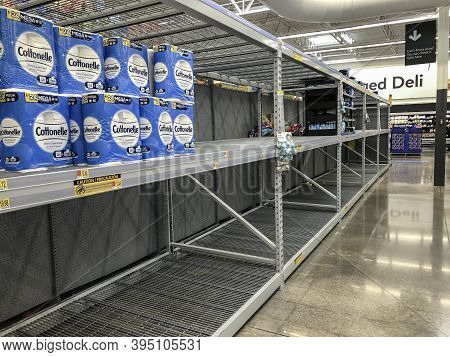 Indianapolis - Circa November 2020: Empty Toilet Paper Shelves At A Retailer. A Second And Third Wav