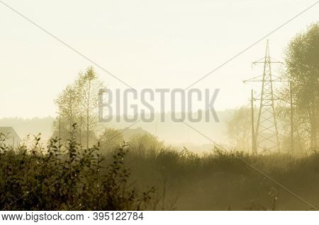 Sunset In The Background Of The Road And Fields With Grass And Trees.