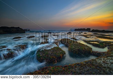 Amazing Seascape. Ocean With Moving Wave. Low Lide. Stones Covered By Green Moss And Seaweeds. Conce