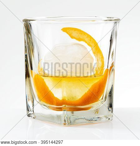 Liquour with an orange peel cocktail