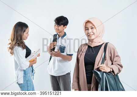 Portrait Of Happy University Lecturer Carrying Bags And Campus Young People Chatting