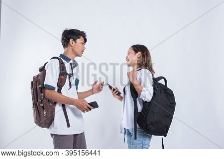 Portrait Of Conversation College Friends Carrying A Bag And Book