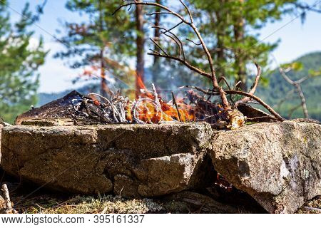 Fishermen's Bivouac On The Island. A Burning Bonfire. Lake Tagasuk. Russia