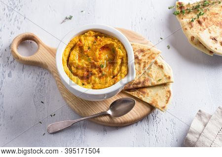 Delicious Healthy Homemade Bean Hummus With Baked Pumpkin, Tahina And Spices With Flat Bread On A Li