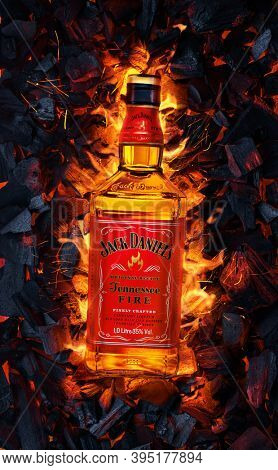 Ukraine, Kiev. November 12, 2020. Bottle of Jack Daniels Whiskey Tennessee Fire top view in burning coals.