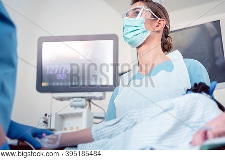 Doctor during colonoscopy in hospital looking at screen at picture from endoscope