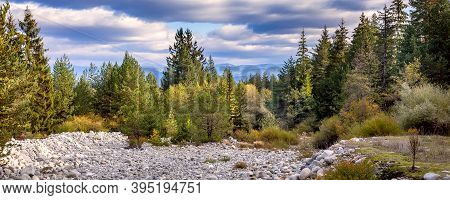 Autumn Scenery Panorama Banner Background With Forest Colorful Trees, Stones And Rila Mountains