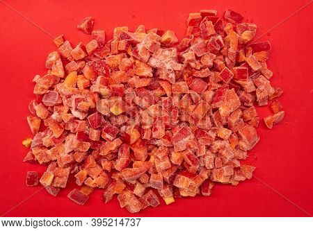 Sliced Red Paprika, Frozen. Pieces Of Vegetables On A Red Board.