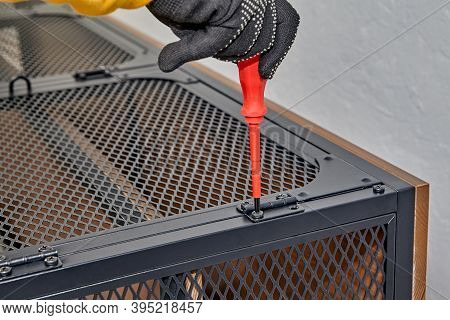 Screwing Bolts In Door Hinges Of Flat Pack Tv Stand By Assembler.