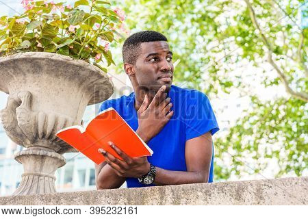 Young African American College Student Studying In New York, Wearing Blue Short Sleeve T Shirt, Stan