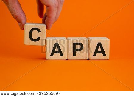 Concept Words \'capa, Corrective And Preventive Actions\' On Wooden Cubes On A Beautiful Orange Back
