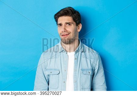 Confused And Uncomfortable Man Looking At Something Strange Or Creepy, Cringe From Bad Advertisement