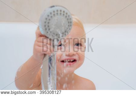 Bathroom. Little Baby Washing With A Bubbles In Bath In A Hat. Cute Little Boy Washing. Child In Cle