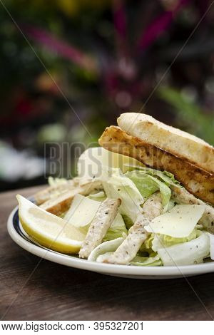 Simple Healthy Orgaanic Chicken Caesar Salad On Wood Table