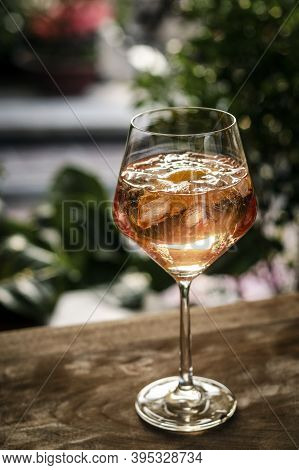 Traditional French 'piscine' Rose Wine Spritzer With Orange Cocktail Drink On Table Outside