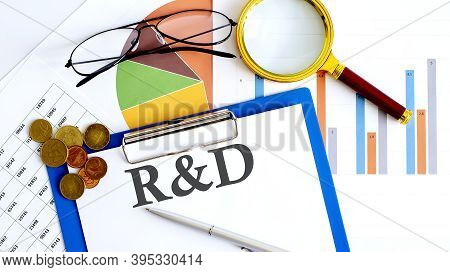 Paper With R And D On A Table With Charts