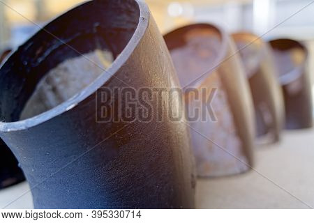 Black Metal Pipes And Adapters Of Different Diameters For Gasification Or Water Supply. Industrial B