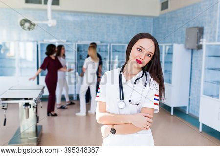 Female Doctor Surgeon Working At Surgery Room And Smiling At Camera.