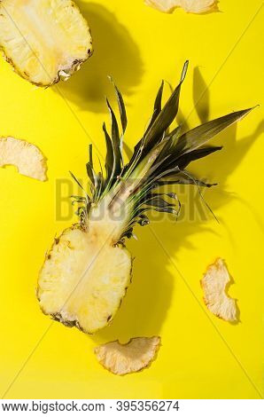 Ripe Juicy Pineapple On Yellow Background And Dried Pineapple Wedges Around. Fruit Chips. Healthy Ea