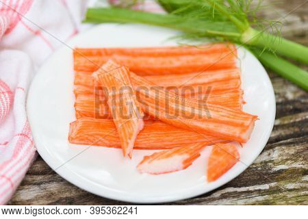 Crab Sticks Sliced On White Plate And Vegetable , Fresh Crab Sticks Surimi Ready To Eat Japanese Foo
