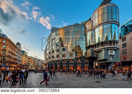 VIENNA, AUSTRIA - DECEMBER 03, 2019: People on Stephansplatz in front of Haas House - famous building in  postmodernist style built in 1990, designed by architect Hans Hollein.