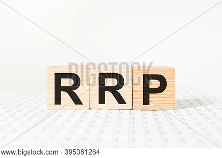 Word Rrp On Wooden Blocks, White Background, Business Concept. Business And Finance