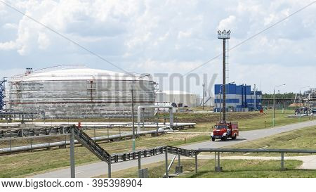 Fire Truck In Industrial Plant. A Large Red Fire Rescue Vehicle In The Chemistry Refinary Plant On P