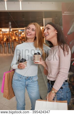 Cheerful Lovely Women Having Coffee At The Shopping Mall Enjoying Seasona Sale