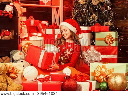 Cheerful Santa Helper Sort Presents. Smiling Shop Assistant. Kid In Santa Hat With Many Gift Boxes. 