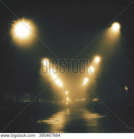 Lanterns On The Street Of The Night City In The Fog.