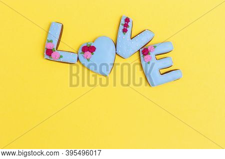 Gingerbread Heart, Cookies In Shape Of Letter Love With Icing On Pastel Yellow Background. Valentine