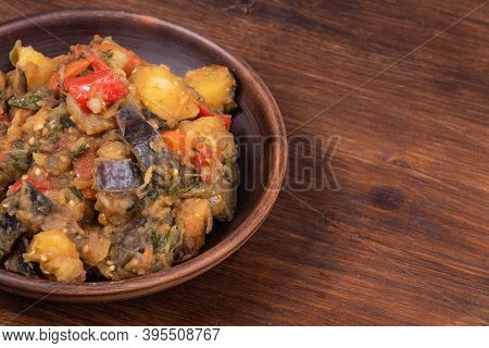 Traditional Italian Vegetable Stew With Potatoes, Eggplant, Tomatoes And Peppers In A Rustic Earthen