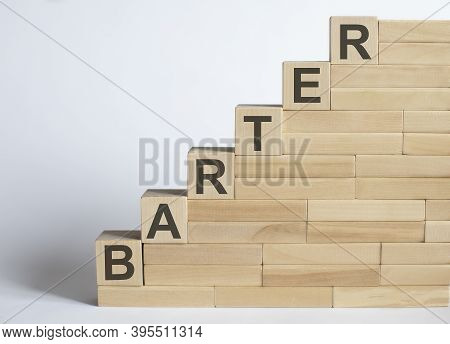 Three Wooden Cubes With Letters Barter On White Table.