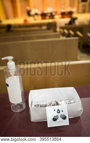 Hand Sanitizer Gel Available At The Entry Of Conference Hall. Social Distancing Stickers At Theatre 