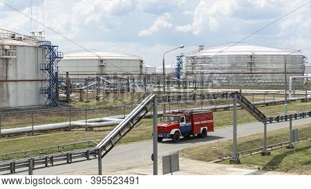 Fire Truck In Industrial Plant. A Large Red Fire Rescue Vehicle In The Chemistry Refinary Plant On P