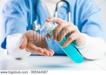 Doctor Using Hand Sanitizer Gel, Medical Specialist Disinfecting Hands With Hand Rub Antiseptic, Cov