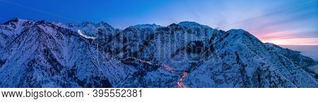Evening Mountains Landscape With A Road To The Chimbulak Ski Resort. Panoramic Photo. Almaty Kazakhs