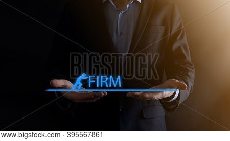 Businessman Holding A Concept In His Hands.the Silhouette Of Man Pushes The Word Firm.business Econo