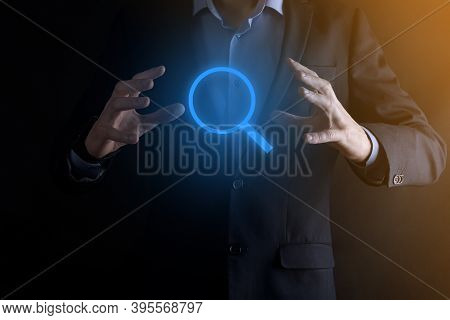 Businessman, Man Hold In Hand Magnifying Glass Icon.business, Technology And Internet Concept