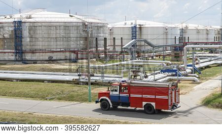 Fire Truck In Industrial Plant. A Large Red Fire Rescue Vehicle In The Chemistry Refinary Plant On P