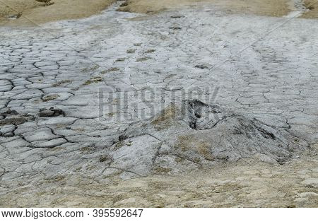Landscape With Cracked Soil From Mud Volcanoes, At Paclele Mari, Romania. Volcanic Rocks And Lava Of
