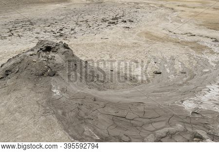 Mud Liquid Flowing From Mud Volcano, At Paclele Mari Mud Volcanoes In Buzau, Romania. Small Volcano-