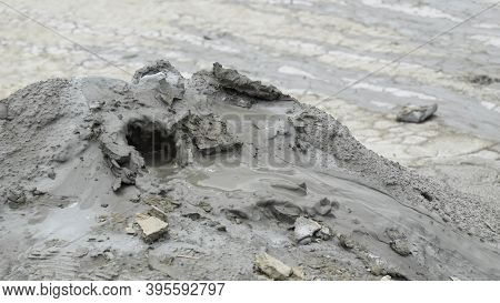 Mud Liquid Flowing From Mud Volcano, At Paclele Mari Mud Volcanoes In Buzau, Romania. Small Volcano-