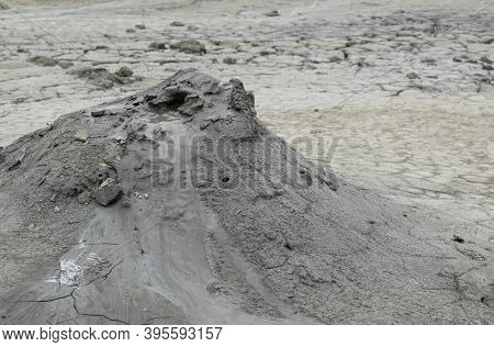Mud Liquid Flowing From Mud Volcano, At Paclele Mari Mud Volcanoes In Buzau, Romania. Small Volcano-