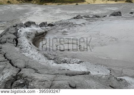 Bubbling Crater Of A Mud Volcano. Close Up View Onto Gas Bubble Exploding In Crater Of Mud Volcano. 