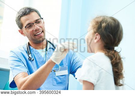 ENT medical examination of little girl by african doctor