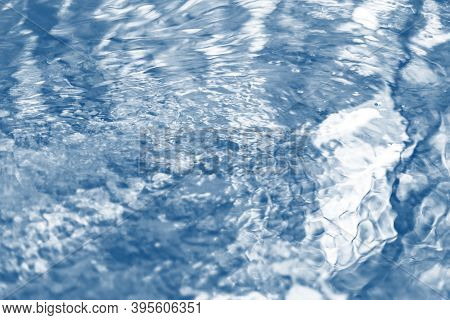 Blurred Water River Abstract Background With Waves At Surface Toned Classic True Blue. Selective Sof