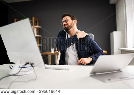 Young Man With Tense Shoulder Pain. Office Posture Problem