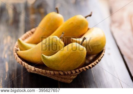 Eggfruit Or Canistel In A Basket On Wooden Table, Thai Fruit, In Thai Names Such As Xiantao, Lamut K
